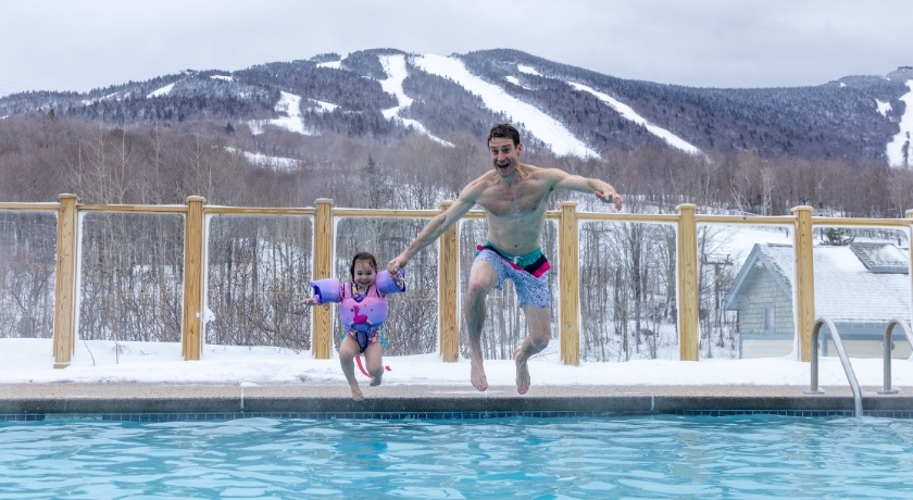 Family time in the outdoor heated pool in winter.