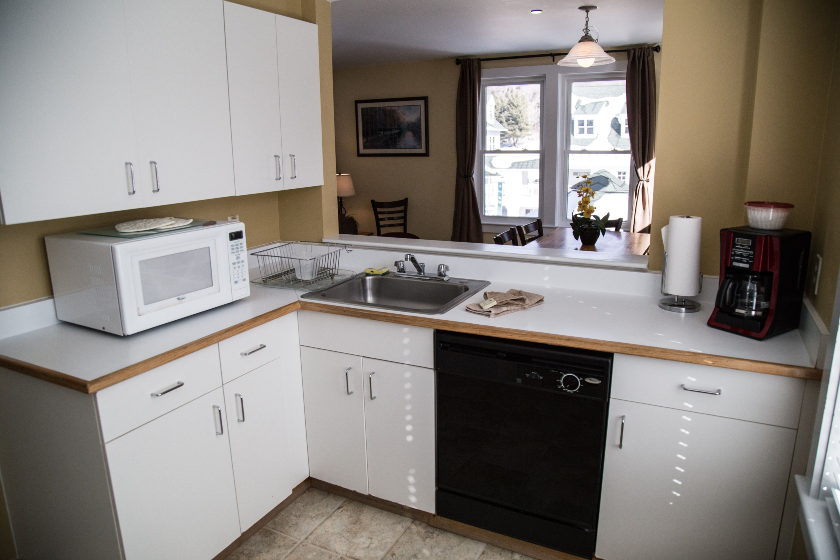 Enjoy preparing meals in a full kitchen, complete with utensils, pots, and pans